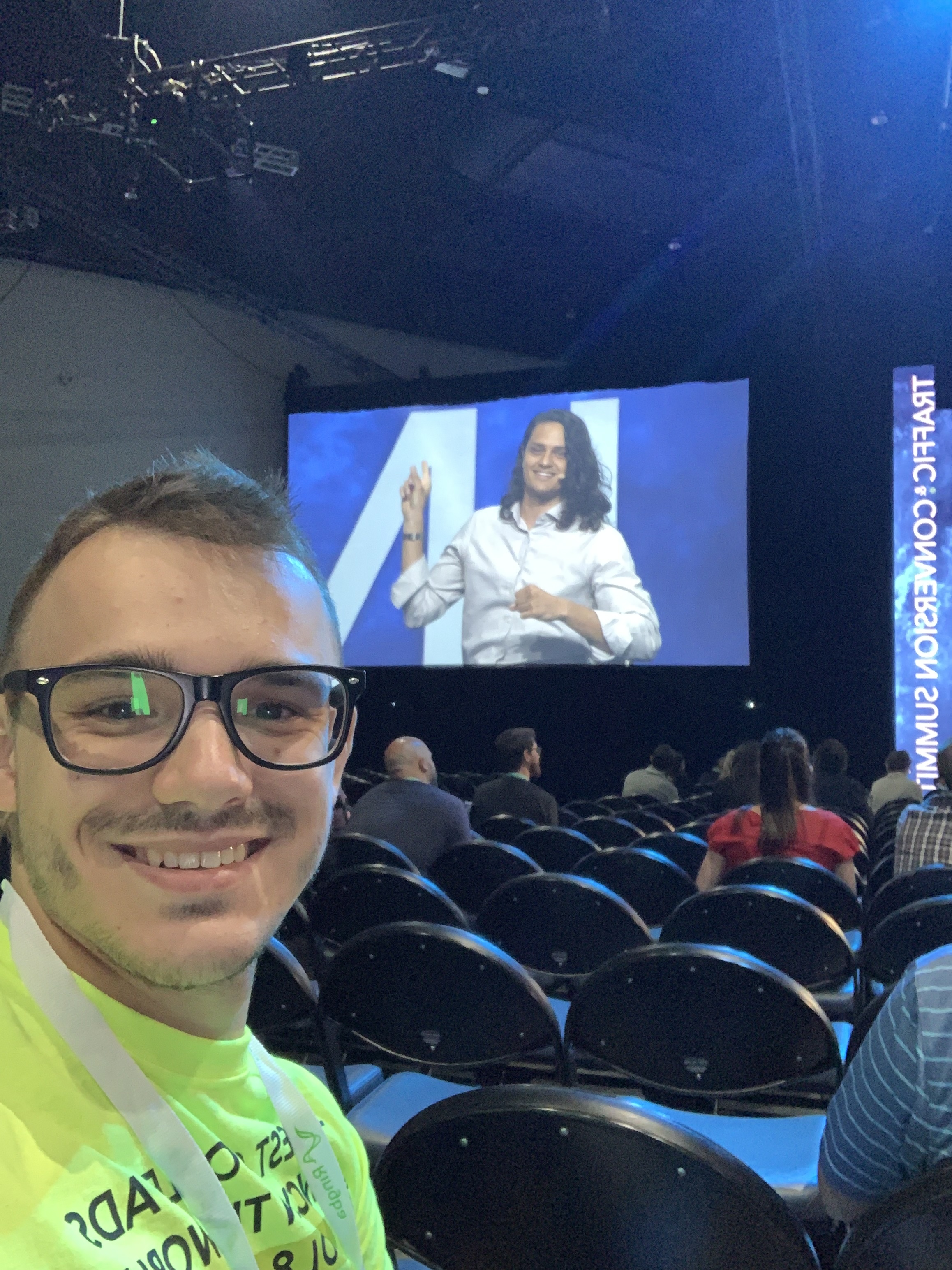 Ivan watching Kasim speak on stage